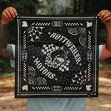 Rider holding the black Rottweiler Motors bandana with smoke drifting through a forest backdrop.