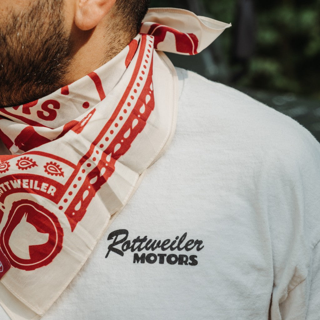 Close-up detail of the red and white Rottweiler Motors bandana worn with a branded T-shirt.