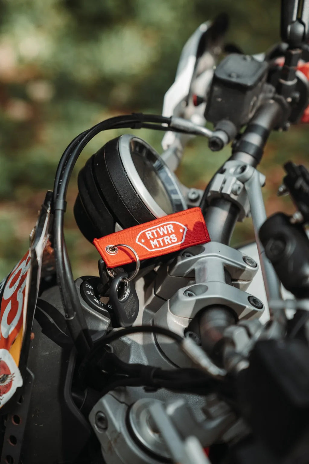 Rottweiler Motors Full Send woven keychain on motorcycle, logo side