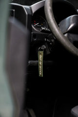 Rottweiler Motors Out of Office woven keychain in Land Rover ignition close-up