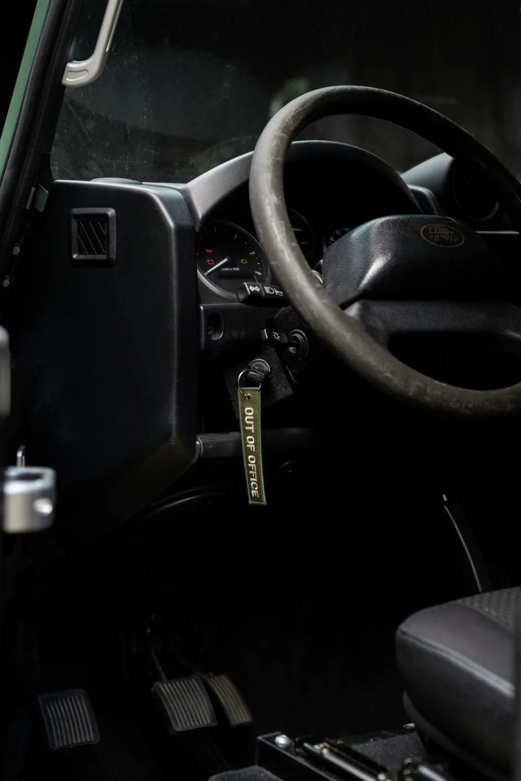 Rottweiler Motors Out of Office woven keychain in Land Rover interior