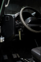 Rottweiler Motors Out of Office woven keychain in Land Rover interior