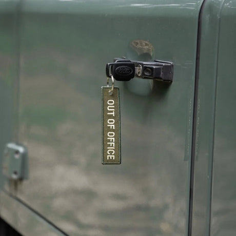 Rottweiler Motors Out of Office woven keychain on Land Rover