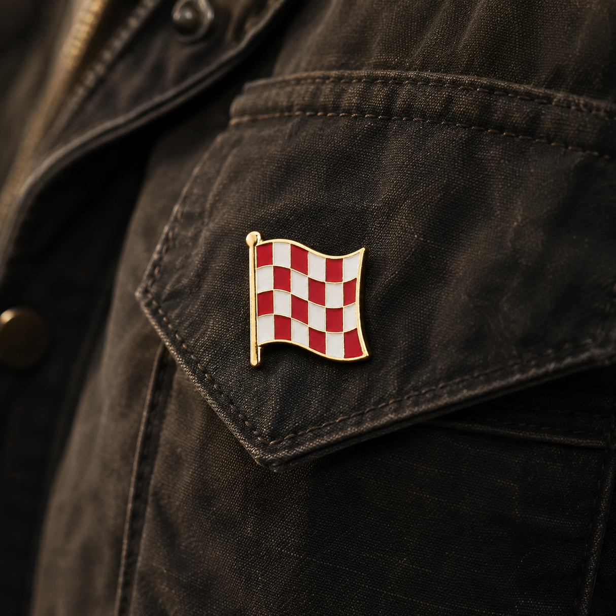 Stage One Pin attached to a dark canvas pocket