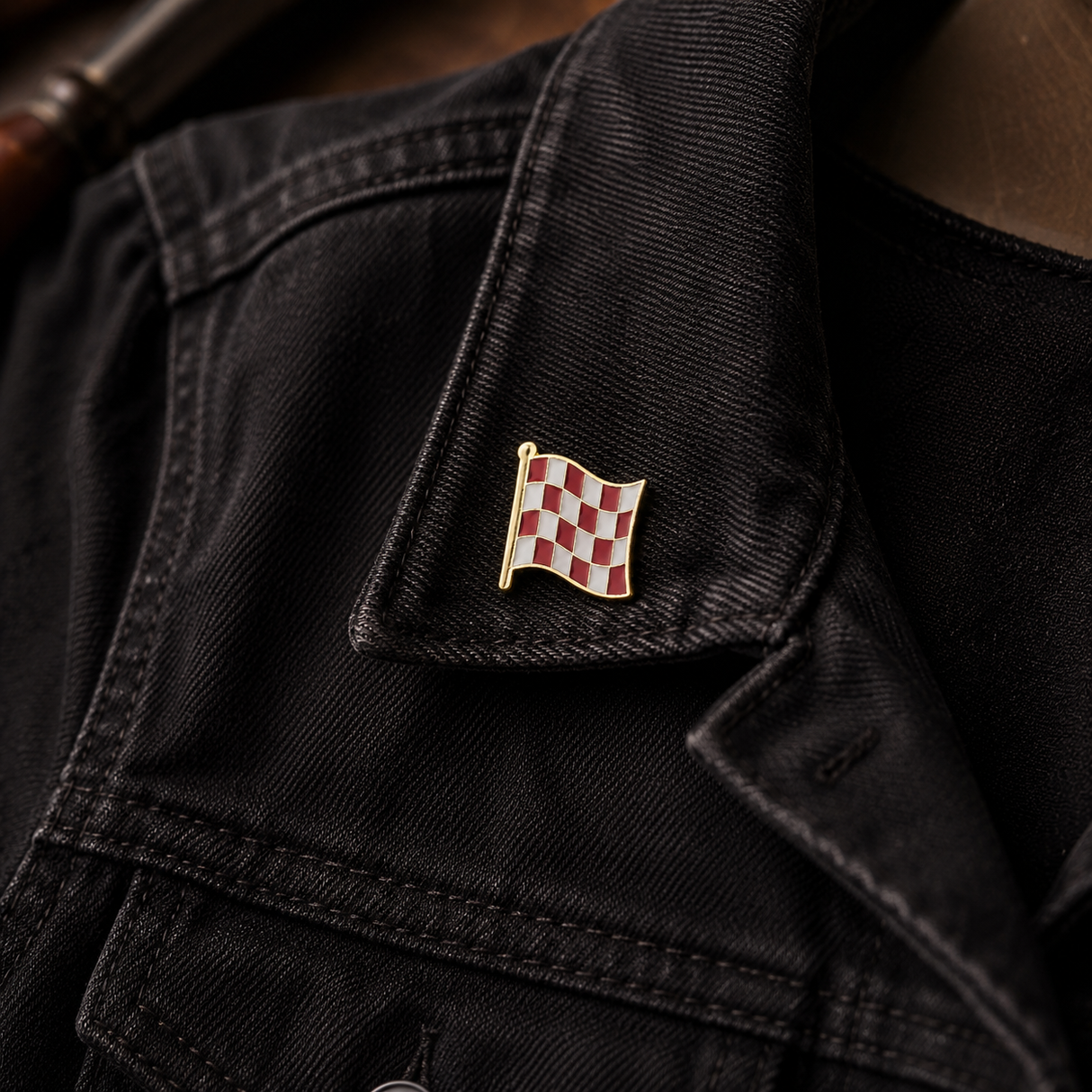 Stage One Pin on a black jacket collar